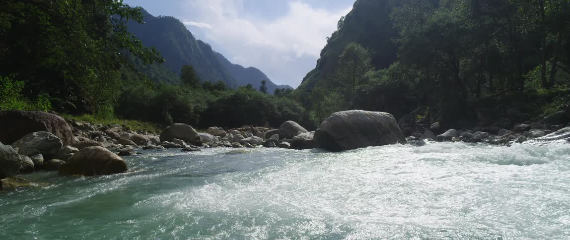 A river flowing over rapids in the mountains on a summer day