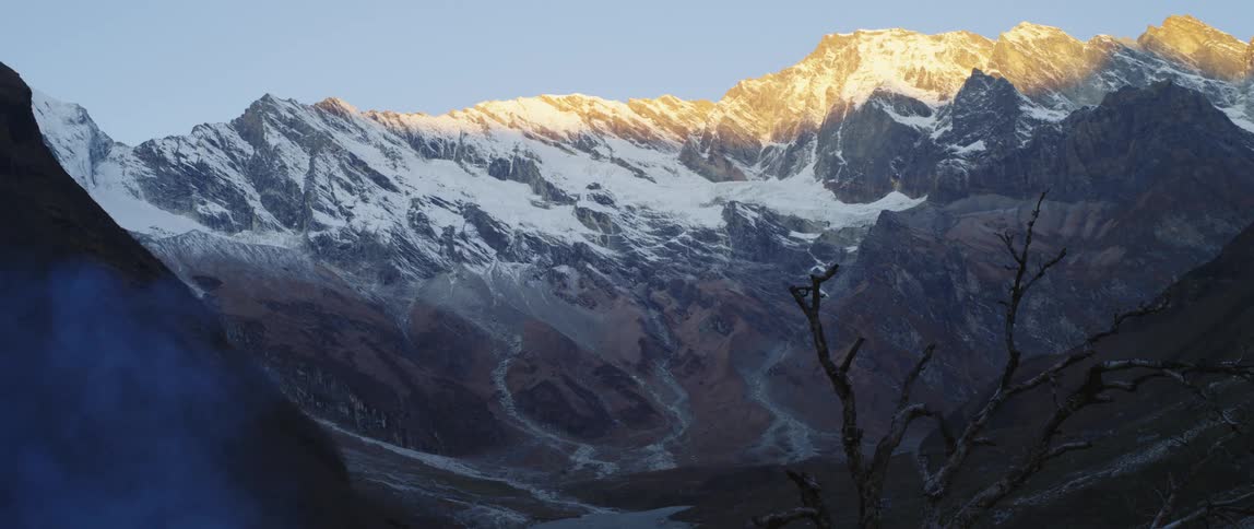 Snow is covering the mountains at dusk
