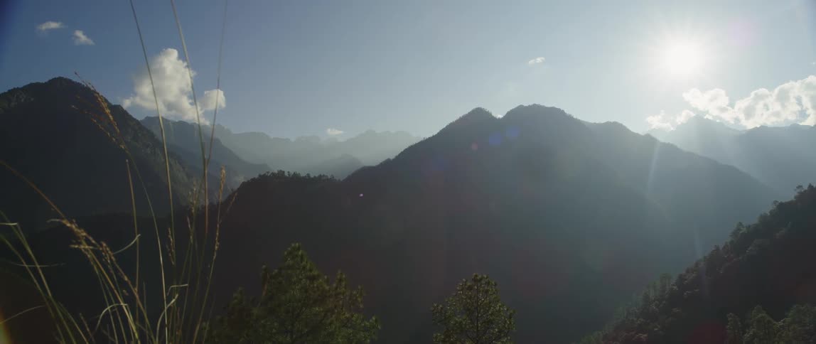 The sun is shining above the mountains