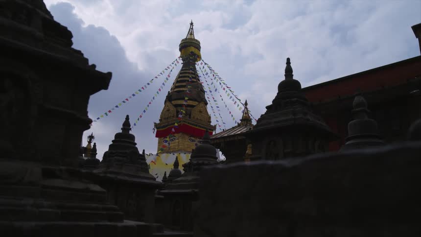 Ornate building and surroundings decorated with small flags under cloudy sky