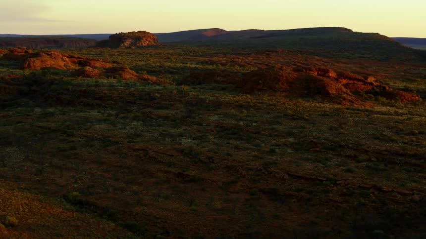 Wide empty grassland with rocks at dawn