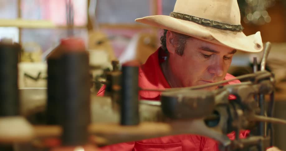 Man working with small vintage machine