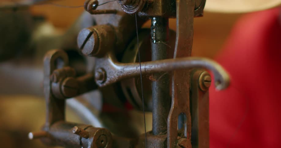 Close view of mechanisms on vintage sewing machine in use