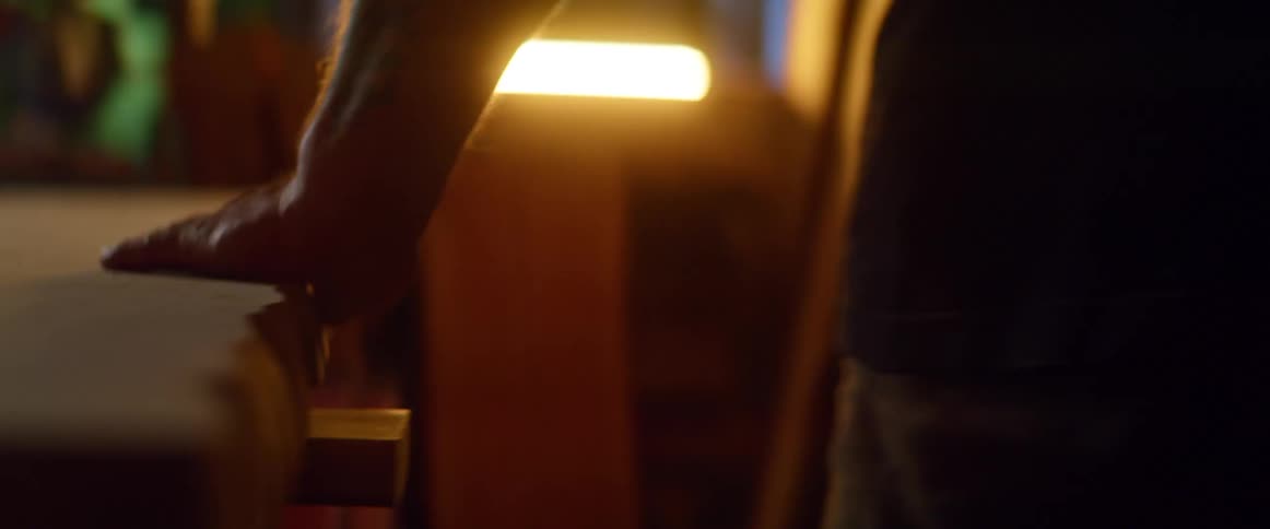 A man is working on a piece of wood in the room