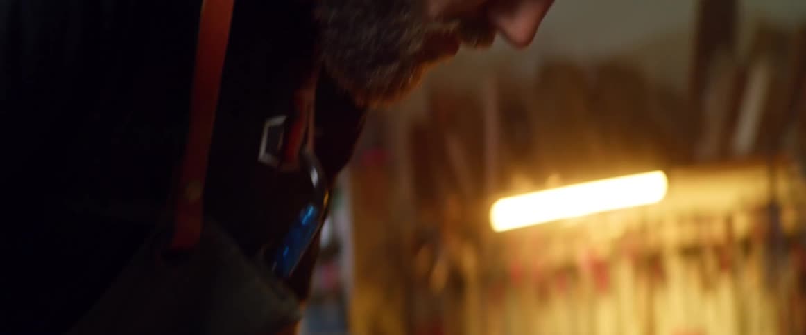 A man chiseling wood in a garage