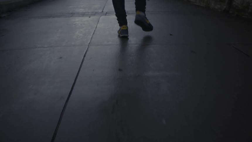 A person is walking along a sidewalk