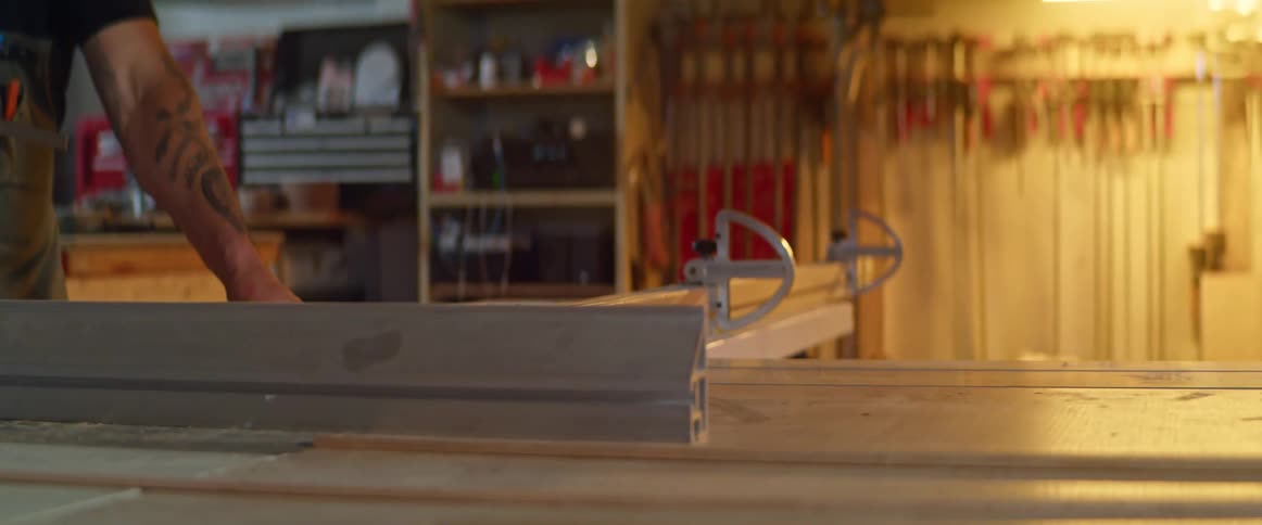 A man cutting wood on a table saw