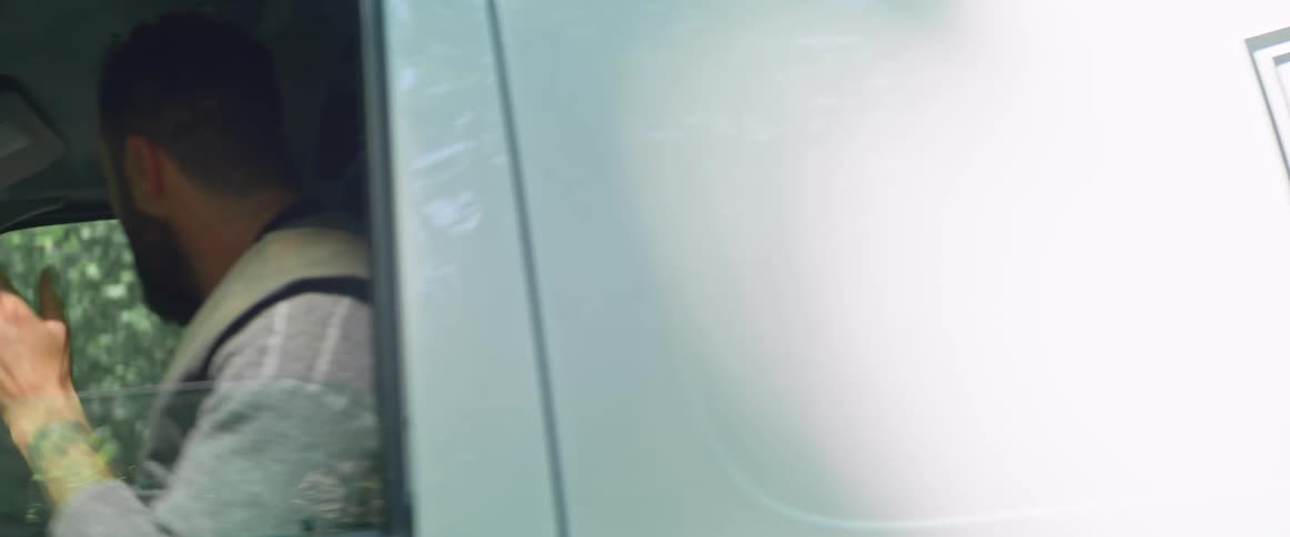 A man driving a company vehicle