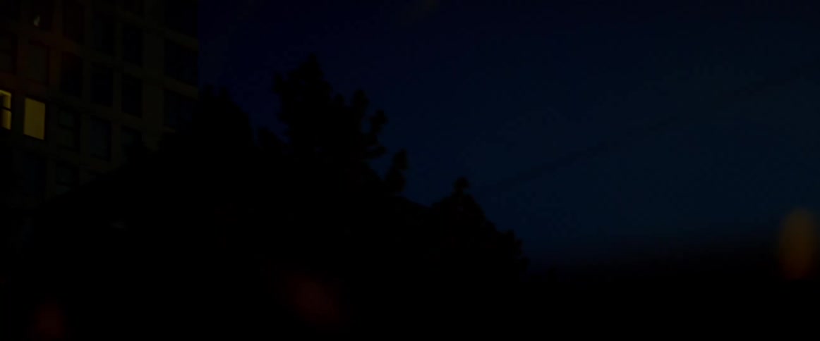 A vehicle is driving at night