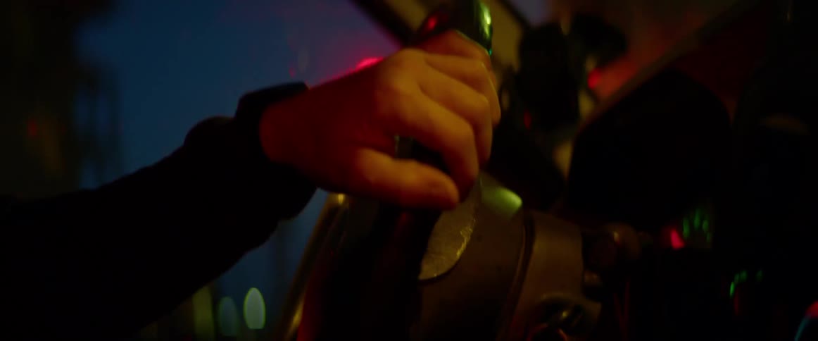 Hand on steering wheel driving car at night