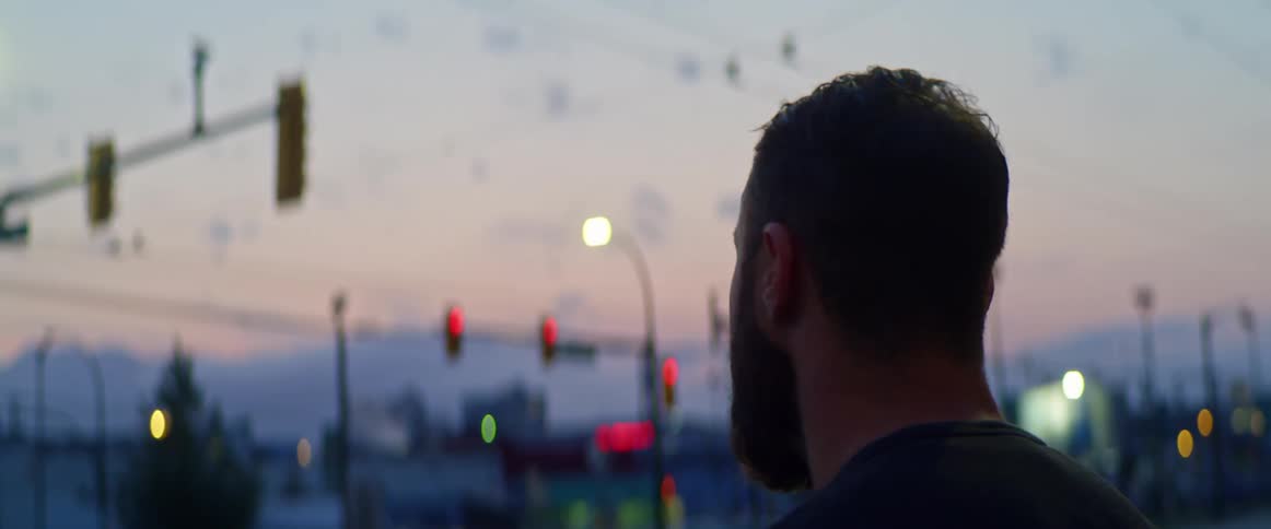 A man is in a downtown city and goes into a building