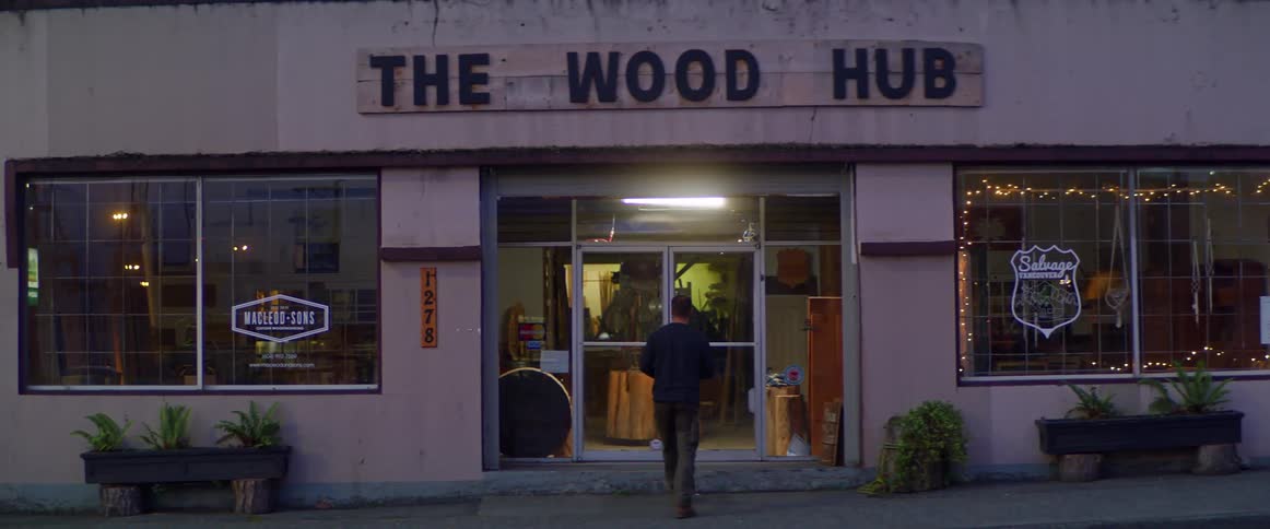 Man takes sip from coffee mug before dumping remainder and walking into store