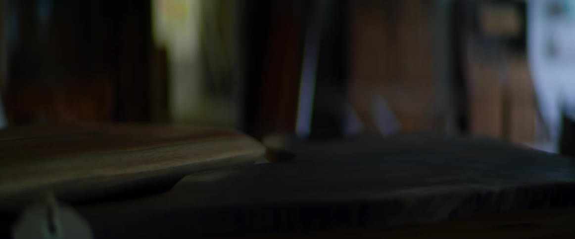 A table with pieces of wood on it with a window in the background