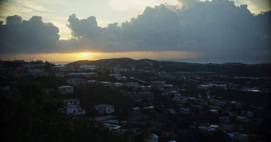 The sun is rising on the homes
