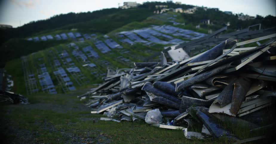 A pile of junk on a grassy hill in the daytime