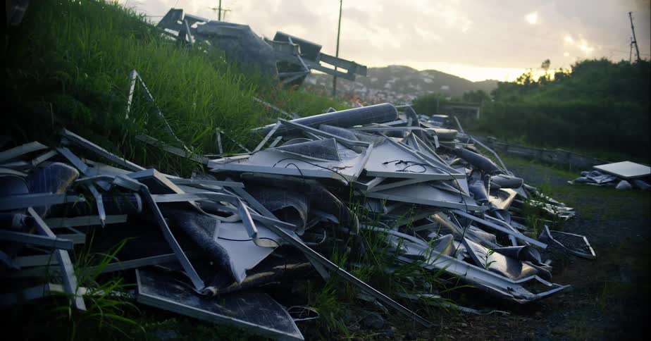 Piles of metal debris on a grassy slope