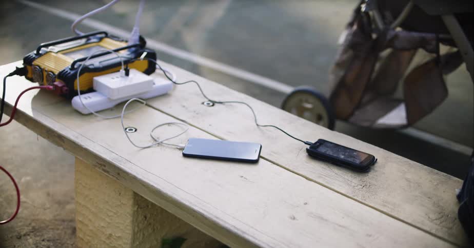 A charger is hooked up to a power strip charging phones
