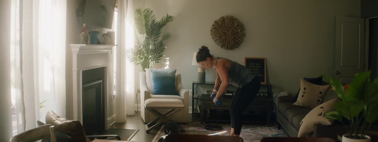 A woman lifting weights at home