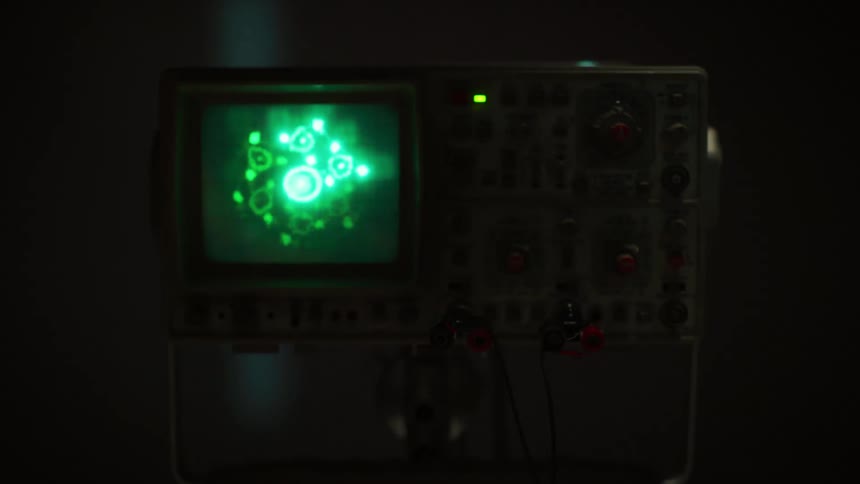 An oscilloscope with lights and buttons and wires