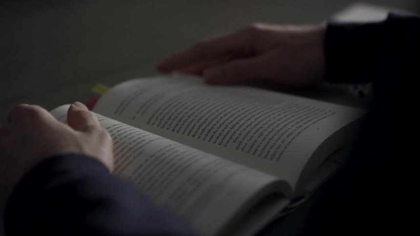 A person is reading a book indoors