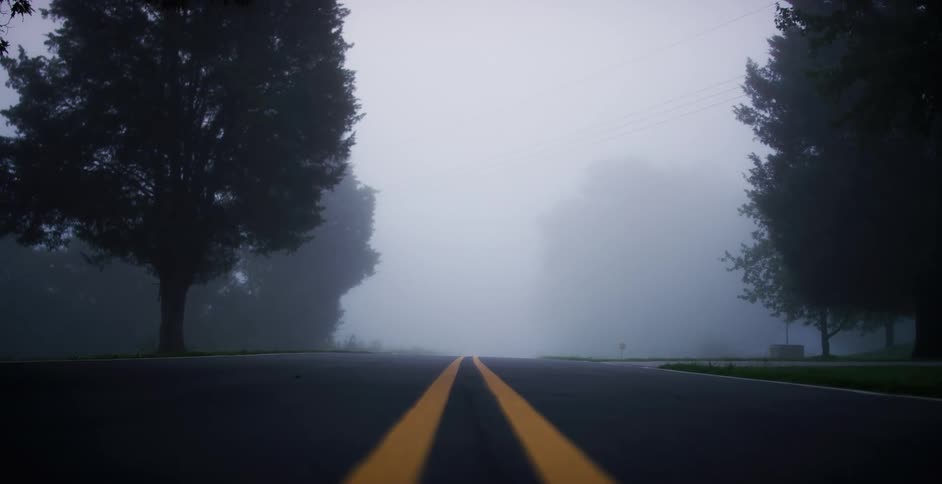 An empty road on a foggy day