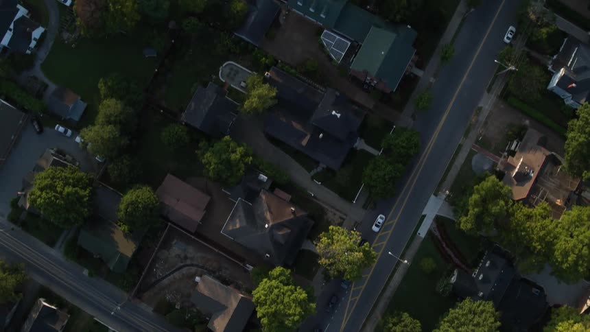 Aerial shot of an an urban area with large houses and trees