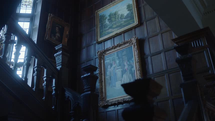 Art work hanging in a staircase in a home