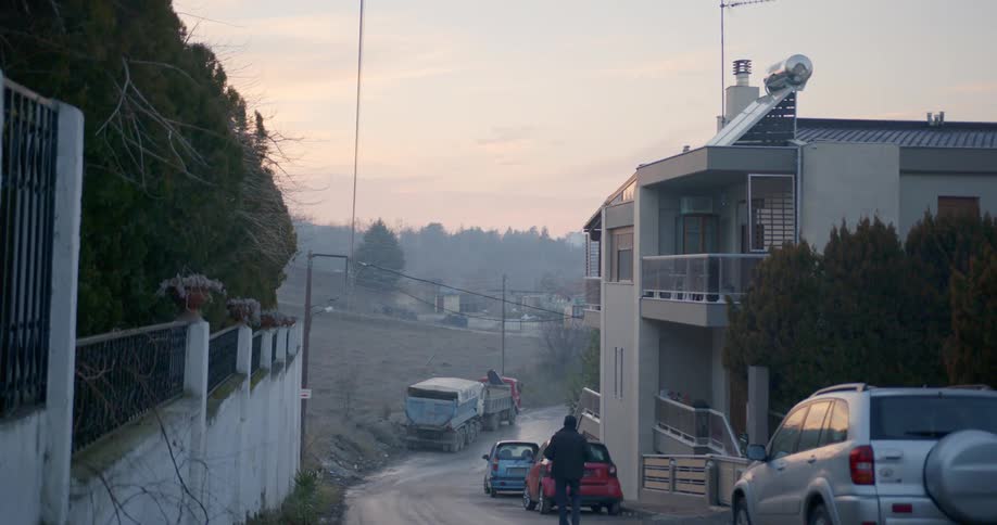 A man walks down a neighborhood street