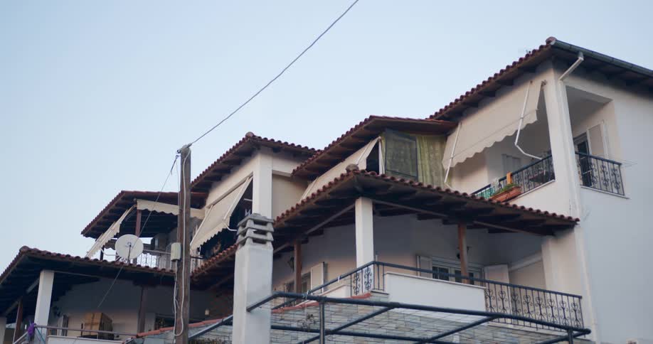 Small rustic style hotel building on a clear day