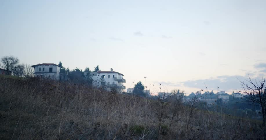 Houses on hillside in small town at dawn