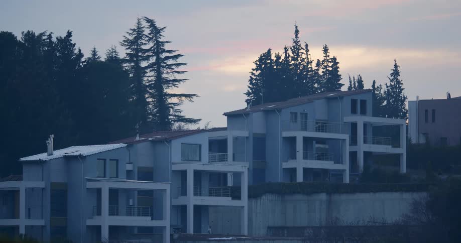Houses on hillside at sunset