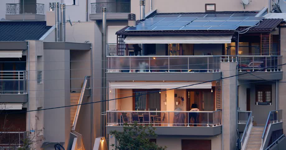 A man playing with a dog on a balcony