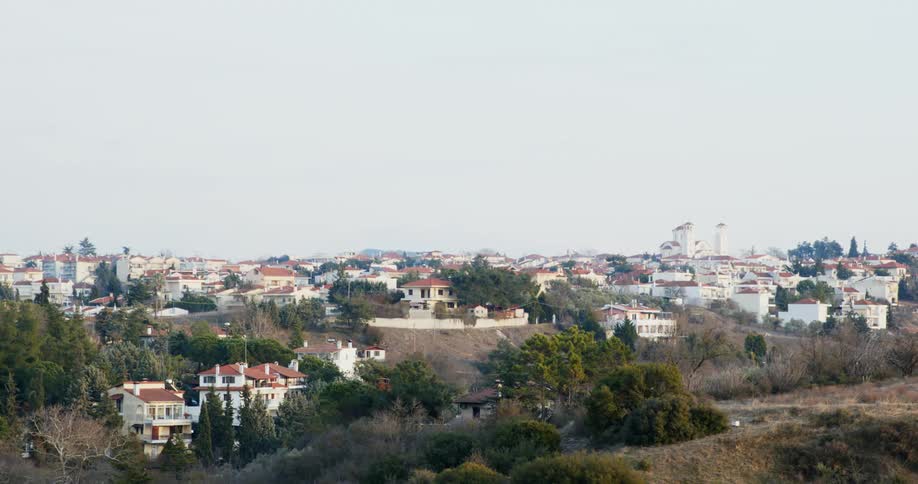 Town of red roofed buildings stretches to the horizon