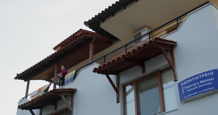 A person is shaking a towel over the terrace