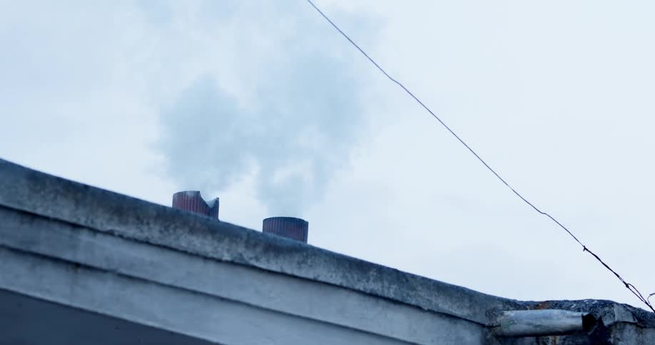 Smoke rises from small metal ducts on rooftop