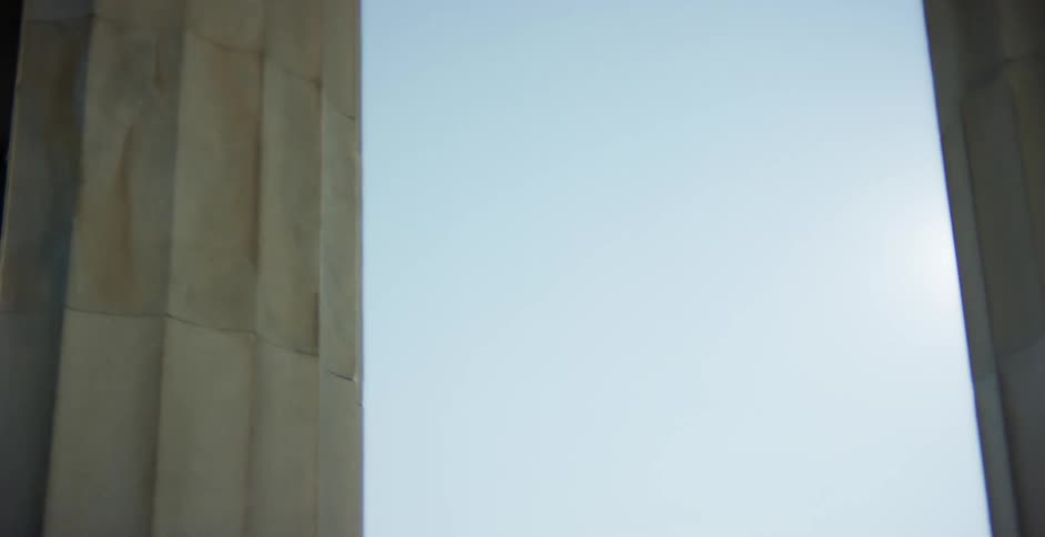 Sunlight shining down on tall pillars on a monument