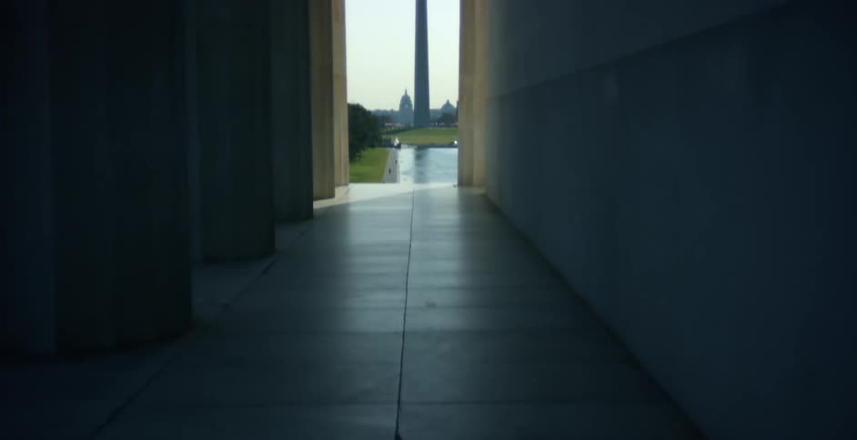 People walking towards a monument in a city