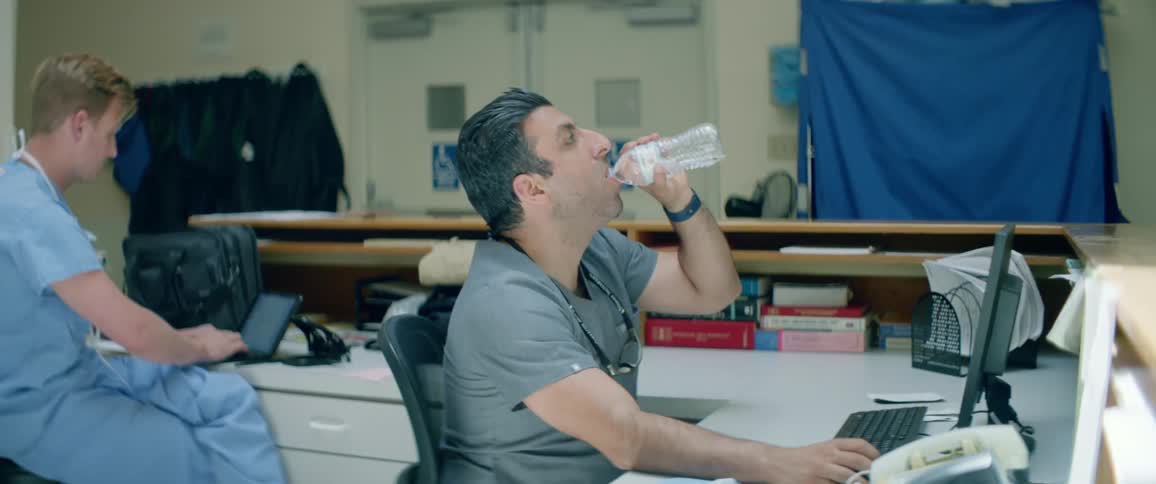 Two people sitting in a hospital at a computer