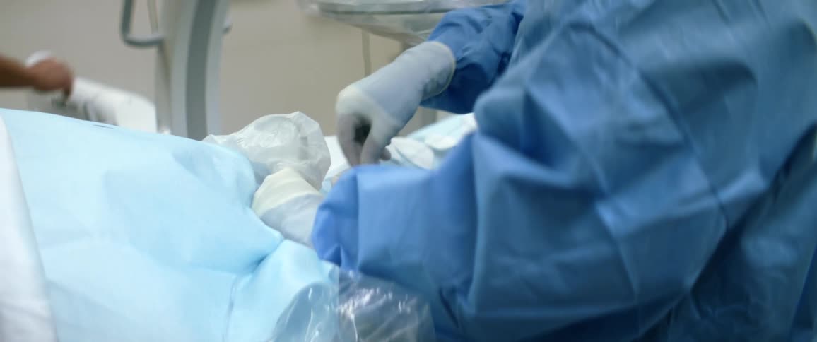 A surgeon performs surgery in an operating theater