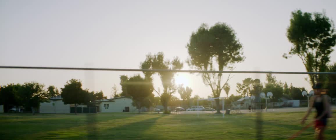 Basketball court and soccer field in park near residential neighborhood