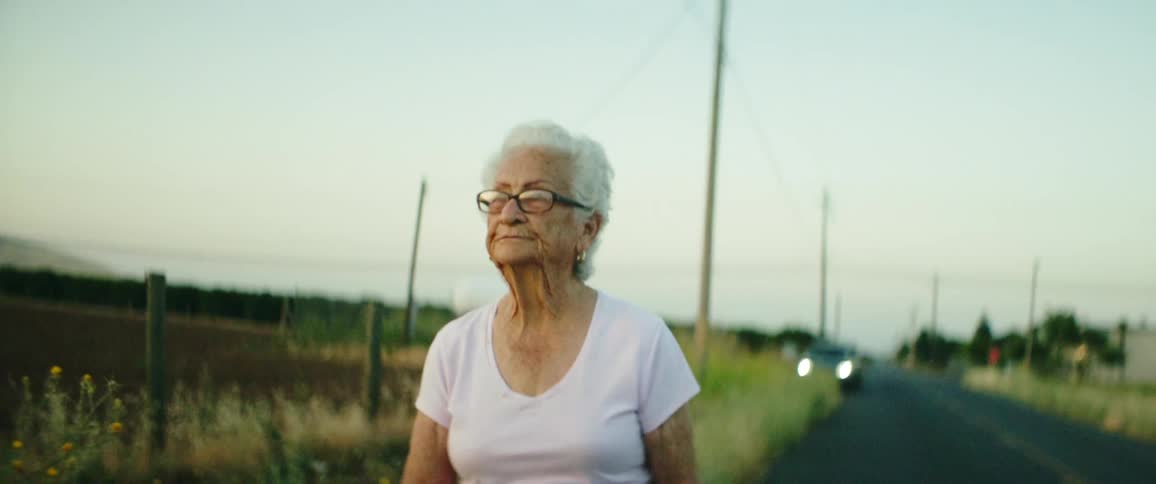 A woman is walking on the road