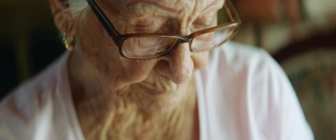 Elderly woman sewing