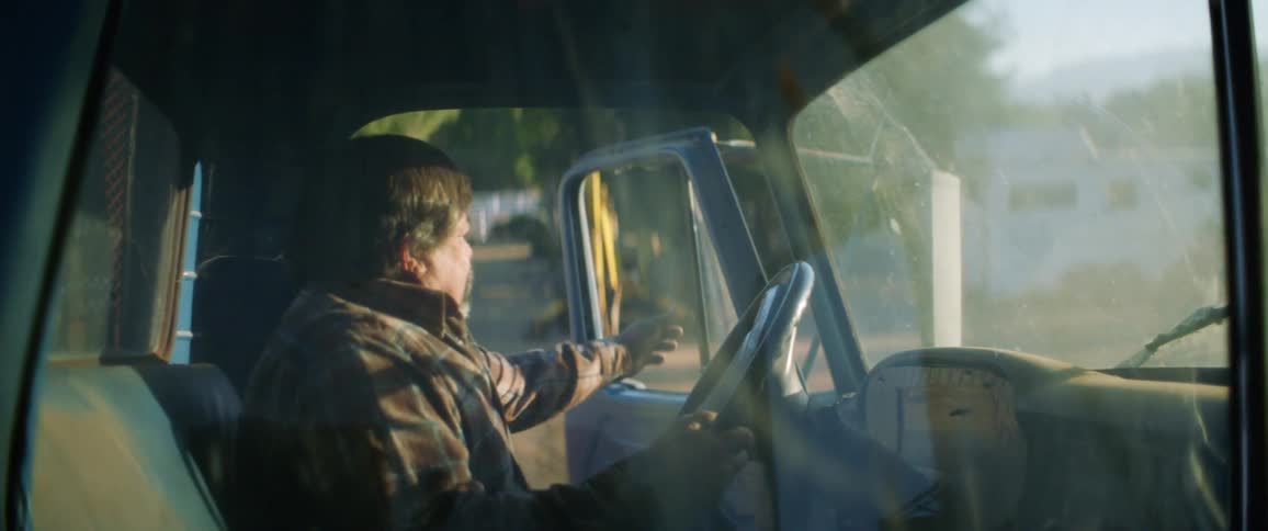 Man sitting in truck pulls door closed