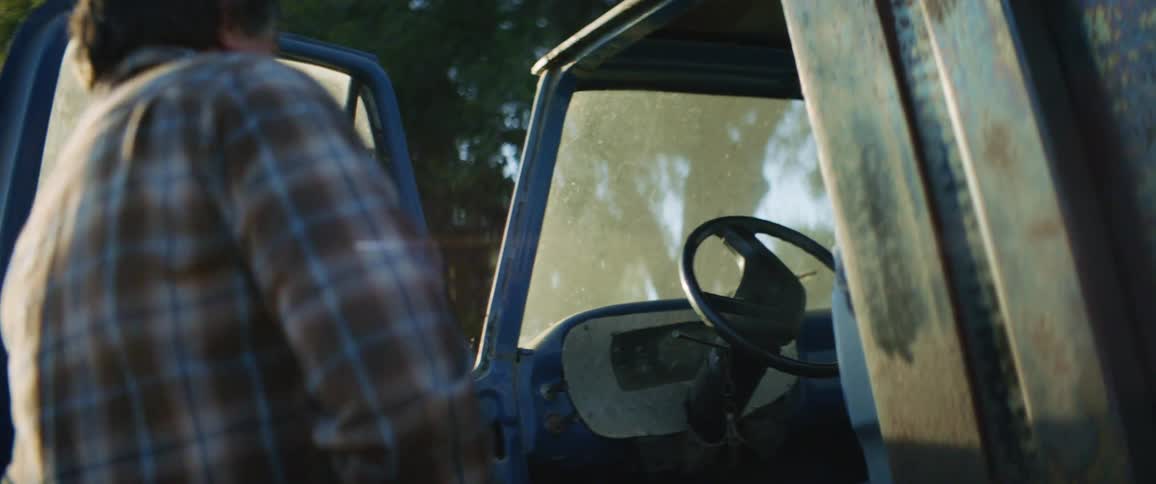 Man opens door of work truck and reaches inside