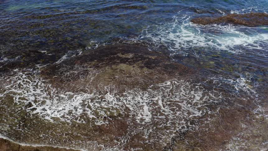 A view of waves crashing on the shore