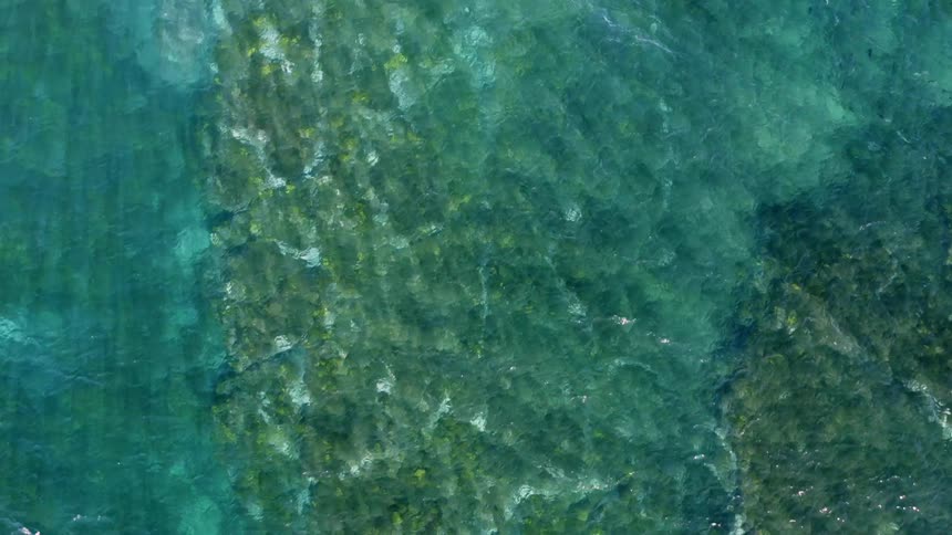Aerial view of ocean water is displayed