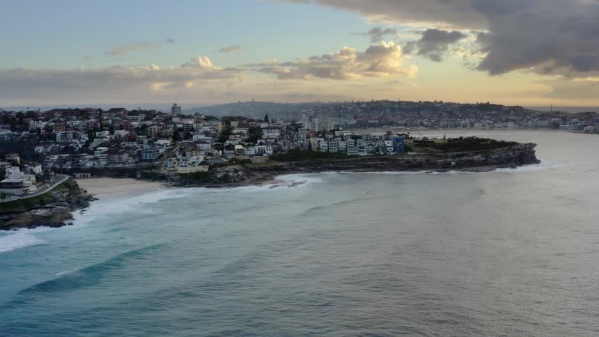 Aerial view of a coastal city with a promontory overlooking the bay