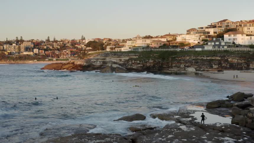 Coastal town near beach and rocky coast