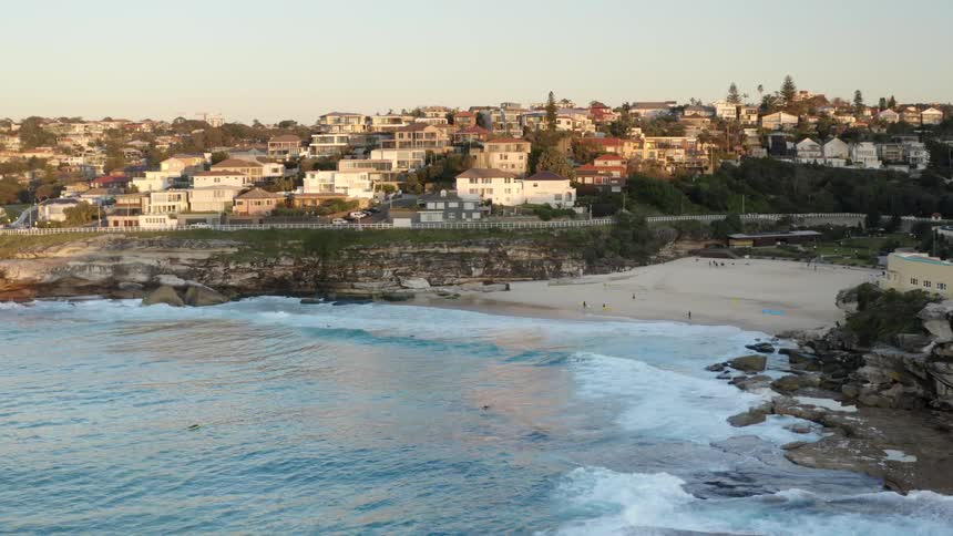 The beach of a bay surrounded by a metropolis