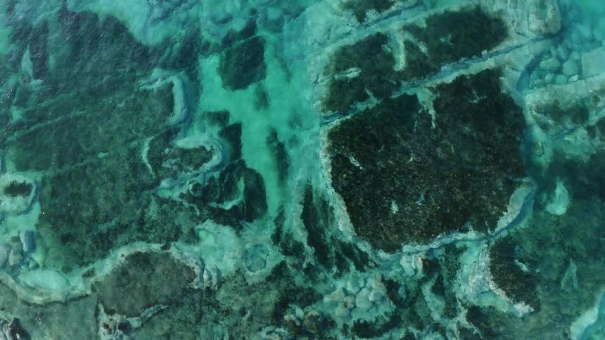 Aerial view of ocean water is displayed
